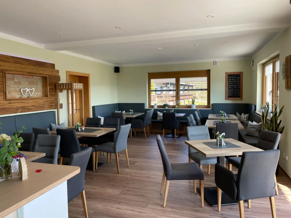 Restaurant dining room with wooden tables and upholstered chairs