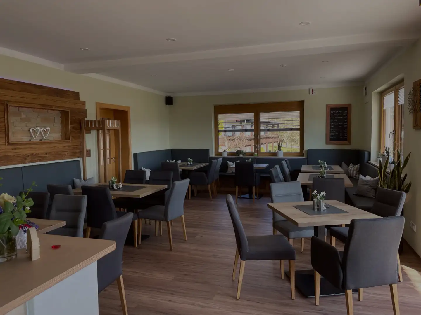 Restaurant dining room with wooden tables and upholstered chairs