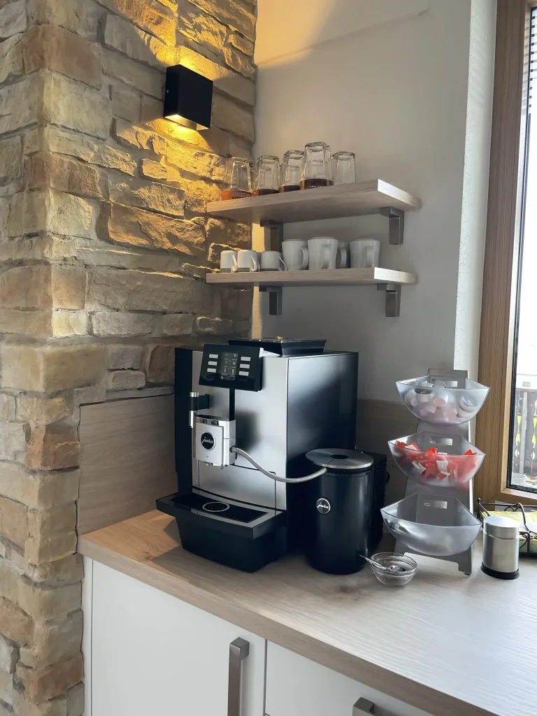Coffee machine and cup shelf behind the bar counter