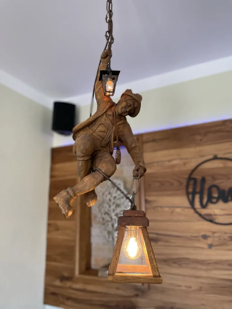 Carved wooden figure with a lantern as a ceiling light