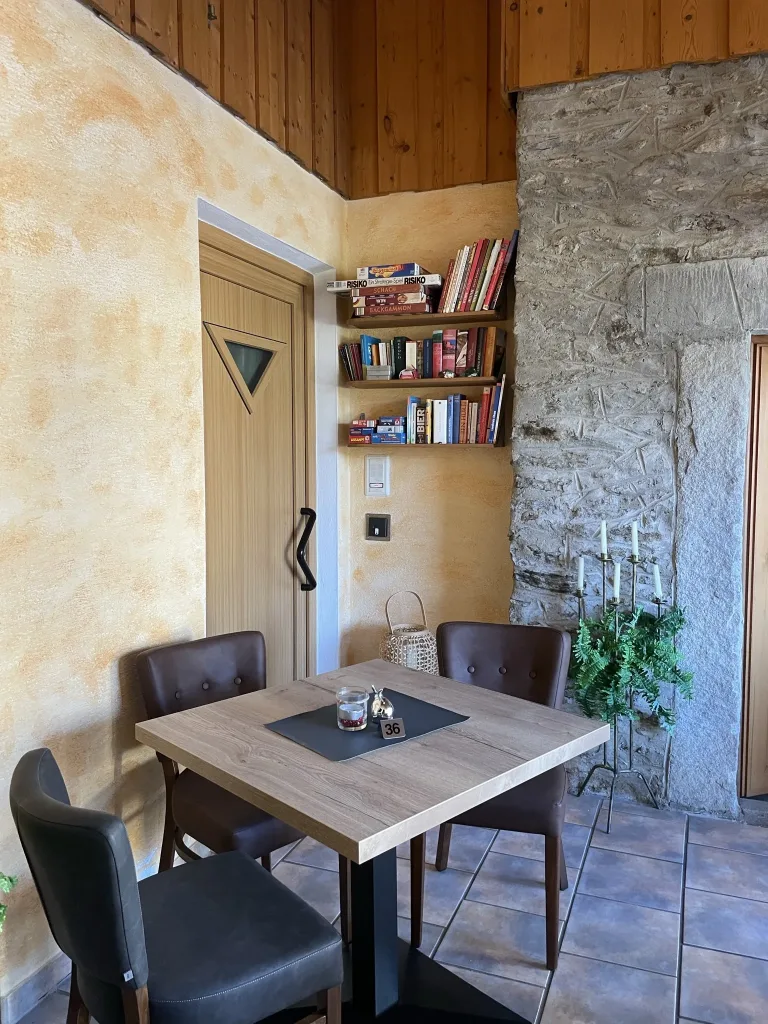 Small table for four next to a natural stone wall