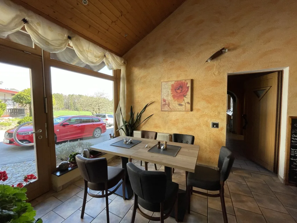 Table by the window in the restaurant in front of a warm-toned wall