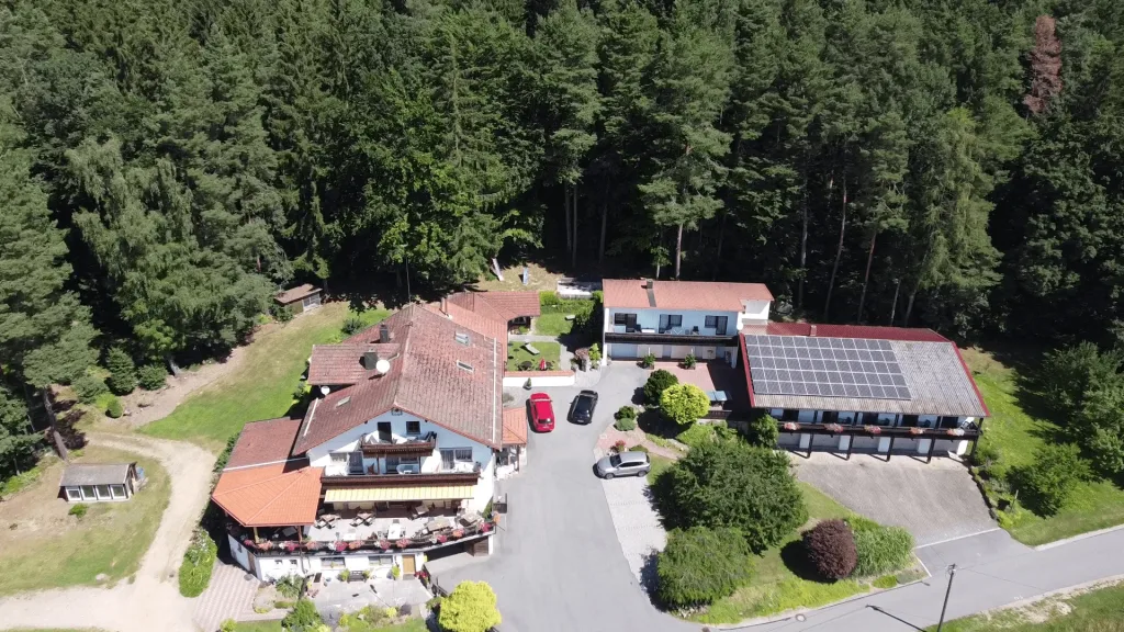 Aerial view of Landhotel Waldesruh and its outbuildings on the edge of the forest