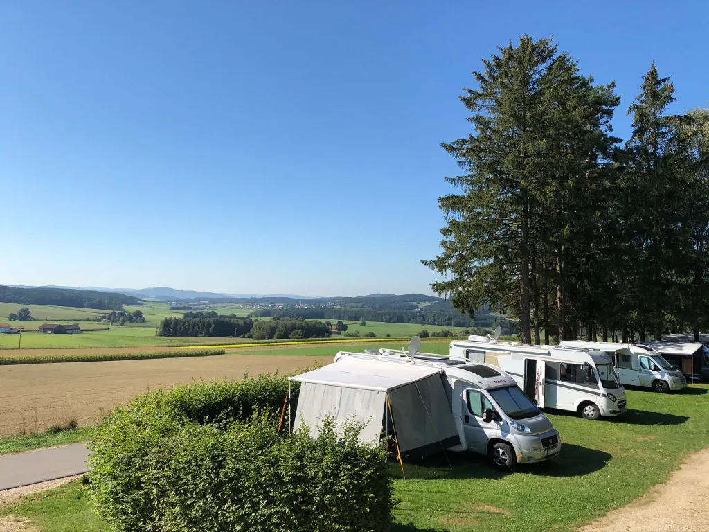 Motorhomes on the campsite with a wide view over the countryside