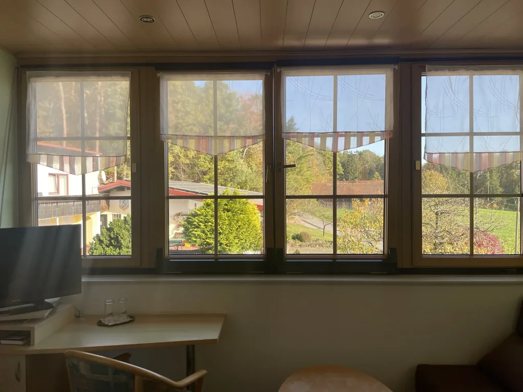 Desk and seating area in front of a wide row of windows